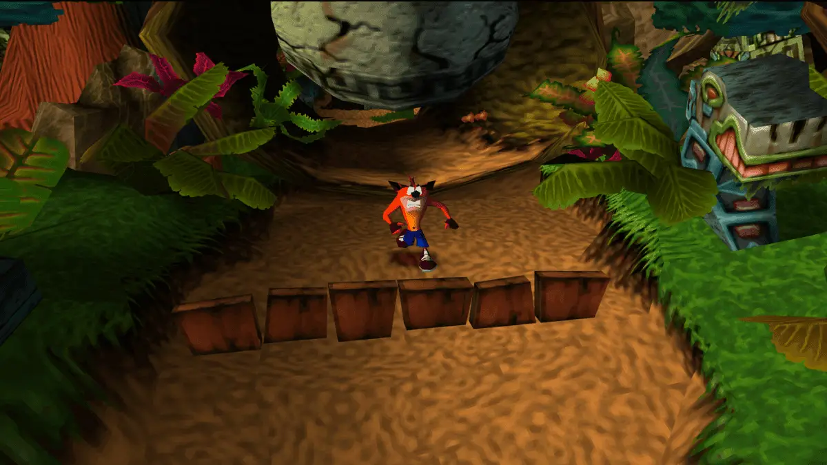 Crash Bandicoot running toward the camera while escaping a giant boulder
